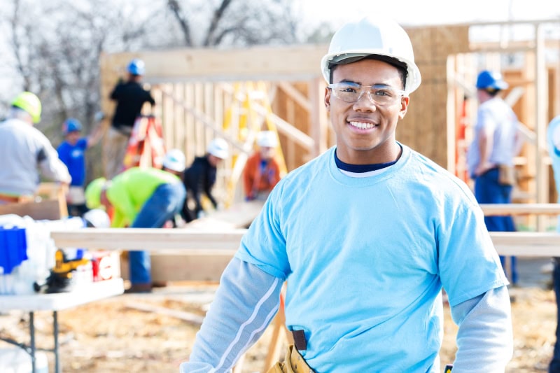 A technician in front of a home being built.