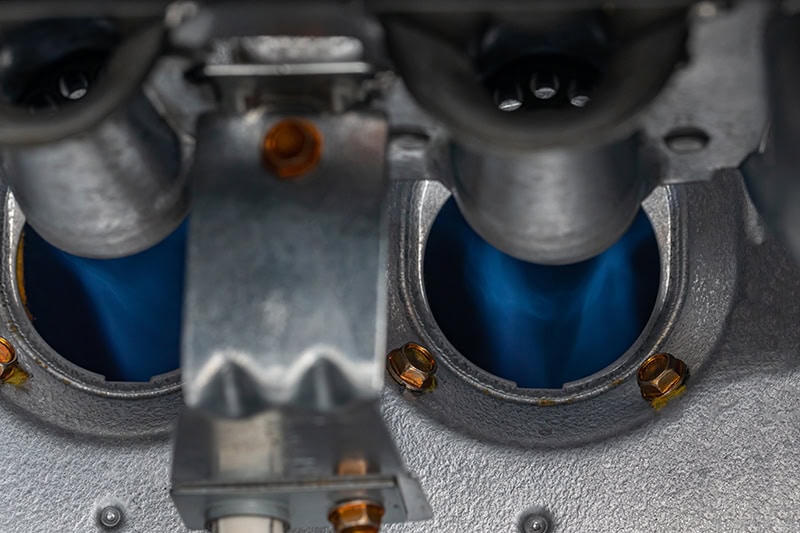 Gas furnace flame burner. HVAC maintenance, repair, service and installation concept.