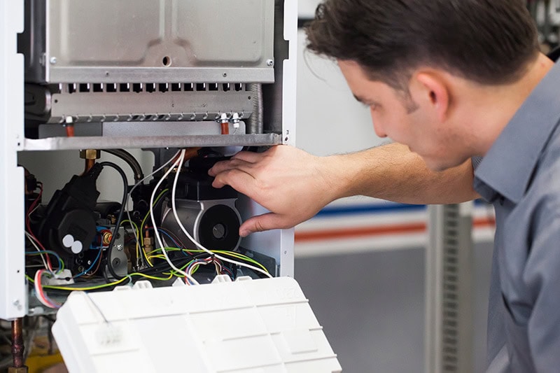 HVAC technician repairing system.