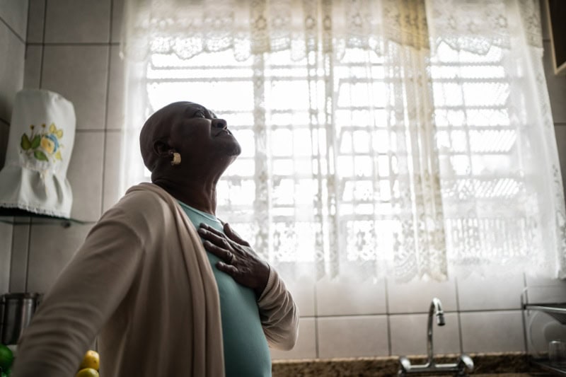 Older woman enjoying the clean air in her home.