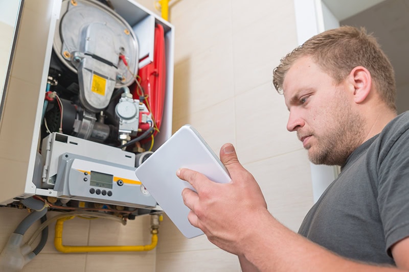 Technician repairs HVAC equipment.