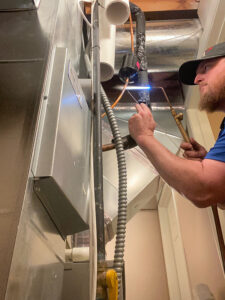 A Design Air technician performing maintenance.